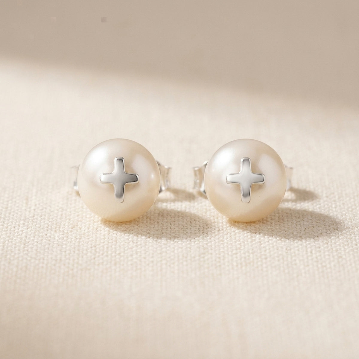 Ohrstecker mit Süßwasserzuchtperle und Silberkreuz – 925er Silber, 9 mm – Detailansicht des Ohrschmucks vor neutralem Hintergrund
