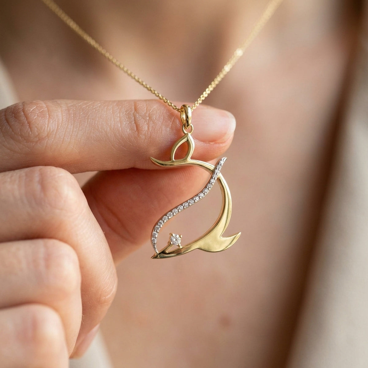 Anhänger stilisierter Delfin mit Zirkonia – 375er Gold, 25 × 20 mm – an einer feinen Kette getragen, zweite Lifestyle-Aufnahme in anderer Perspektive