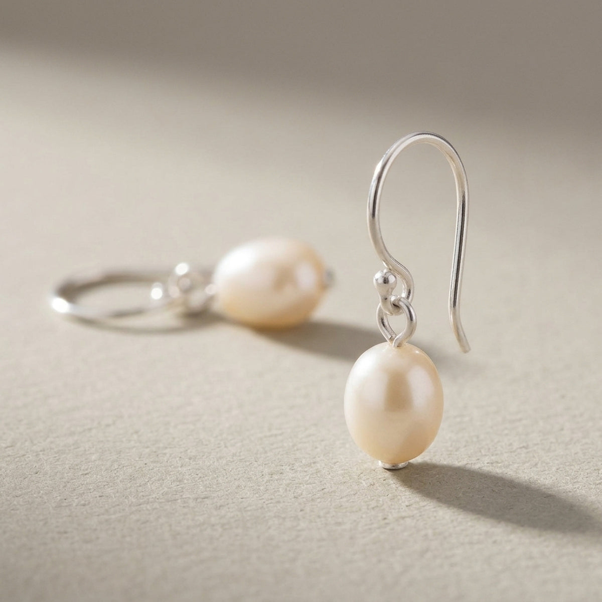 Ohrringe mit Süßwasserzuchtperle roséfarben – 925er Silber, 23 × 7 mm – Detailansicht des Ohrschmucks vor neutralem Hintergrund