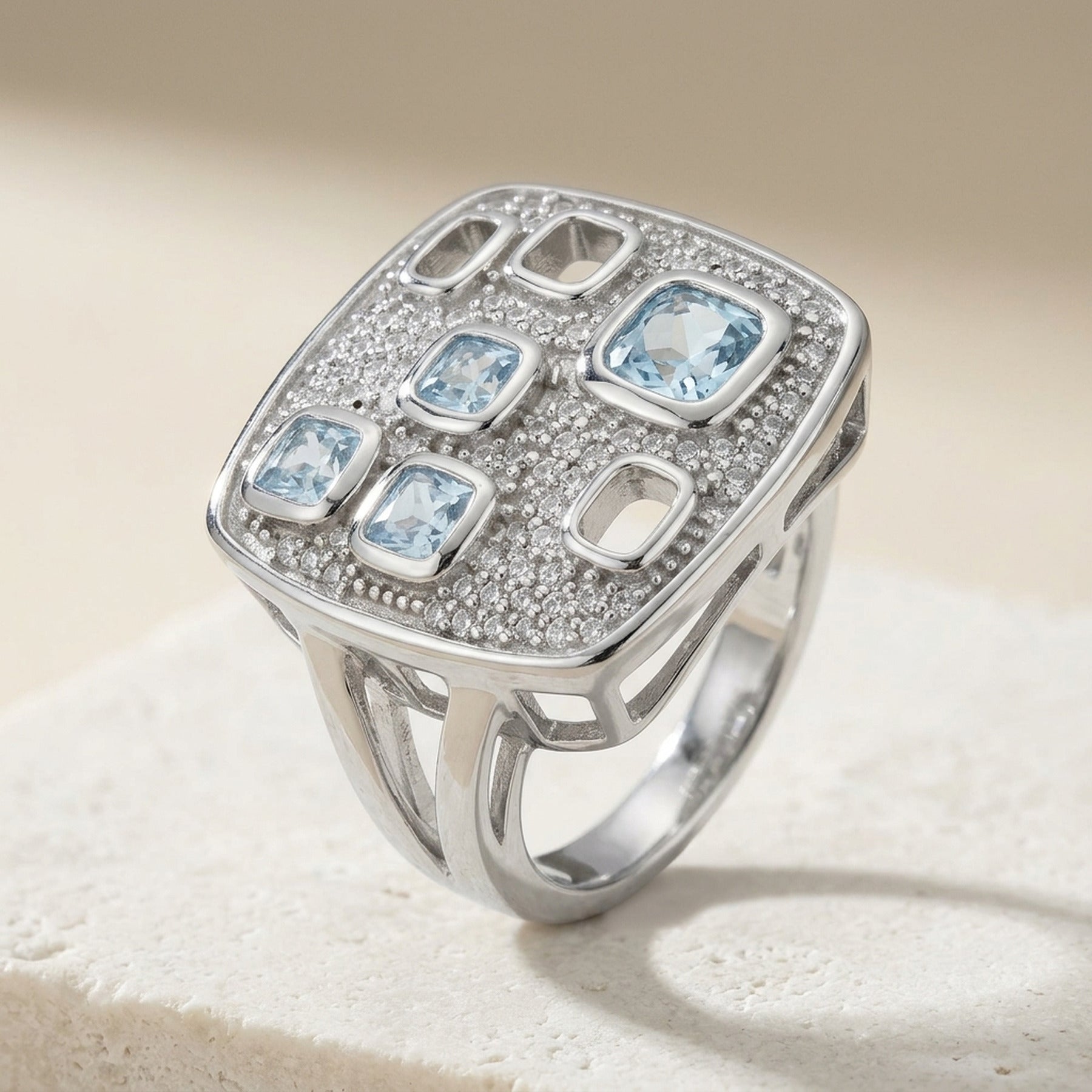 Ring mit aqua- und weißen Zirkonia im Viereck-Design – 925er Silber, 18 mm – Detailansicht des Rings vor neutralem Hintergrund